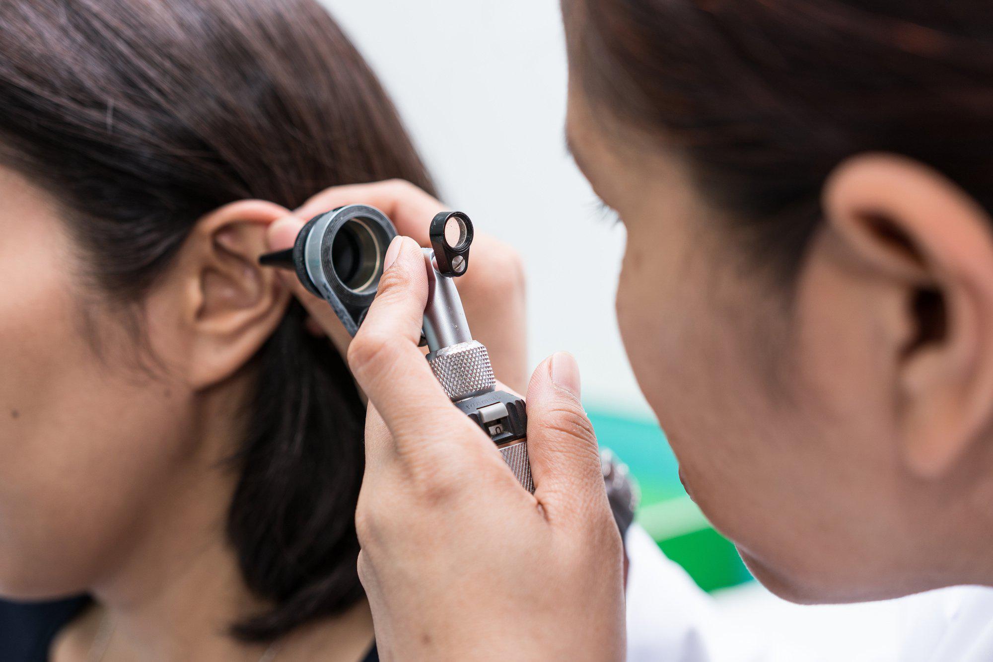 doctor checking the ear of the patient